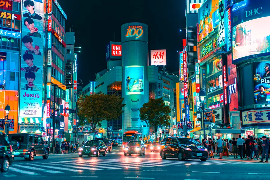 Neon signs and traffic at Shibuya crossing at night